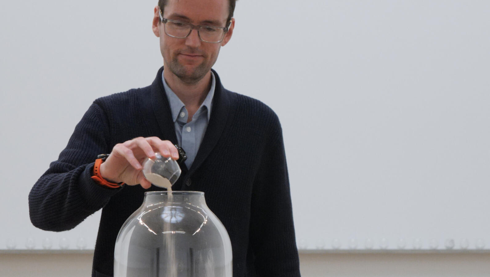 Fisher pouring powder into urn